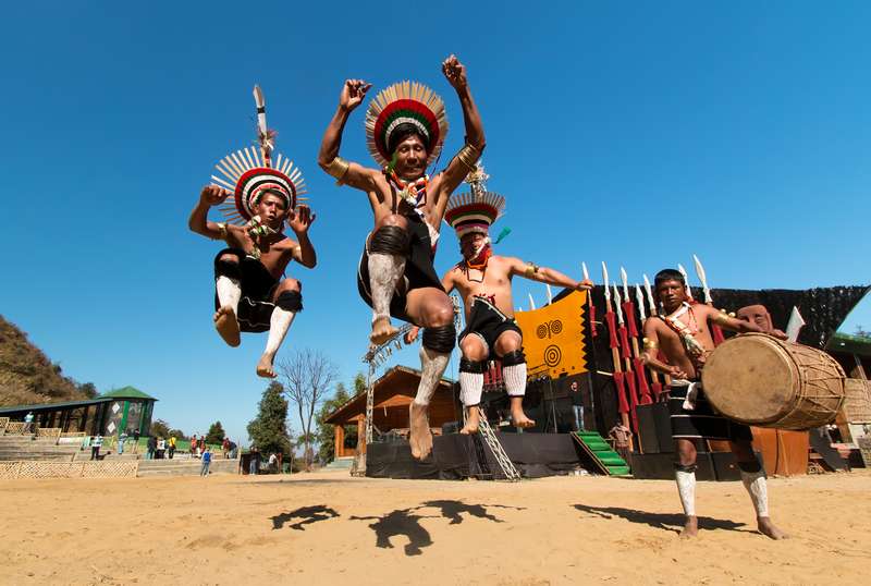 Naga dancers mid-air during a Hornbill Festival performance